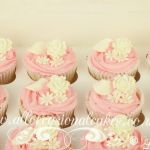 pink icing with white rose cupcakes
